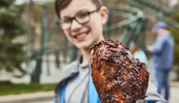 Boy holding turkey leg