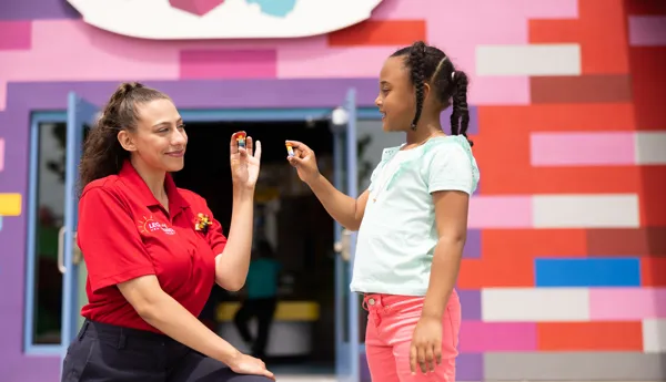 A Model Citizen engages in Minifigure trading with a guest